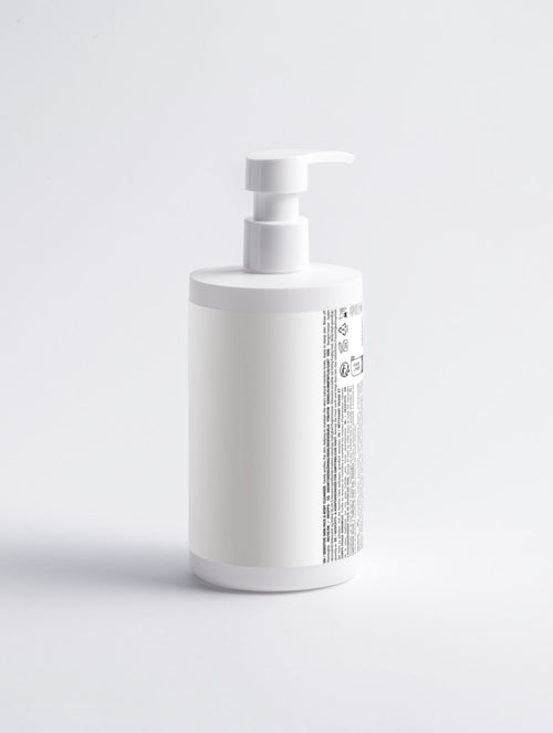 Achterzijde van de witte pompfles gezichts- en lichaamsreiniger van Asmanis ProGel, met productetiket.